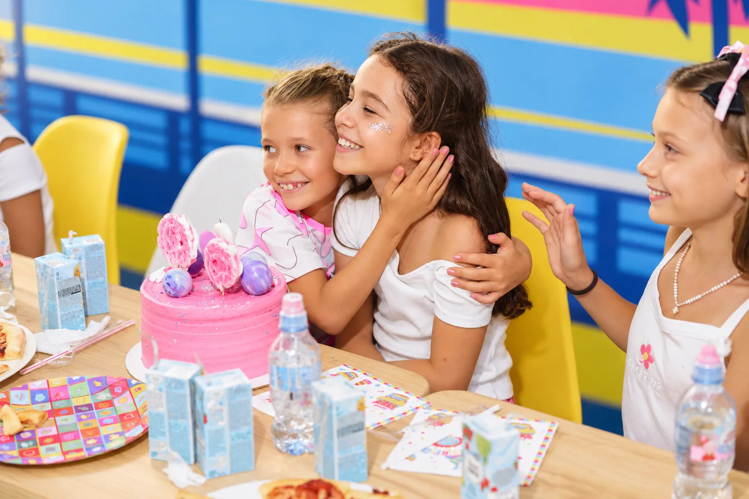 Kids celebrating with a birthday cake at the arena