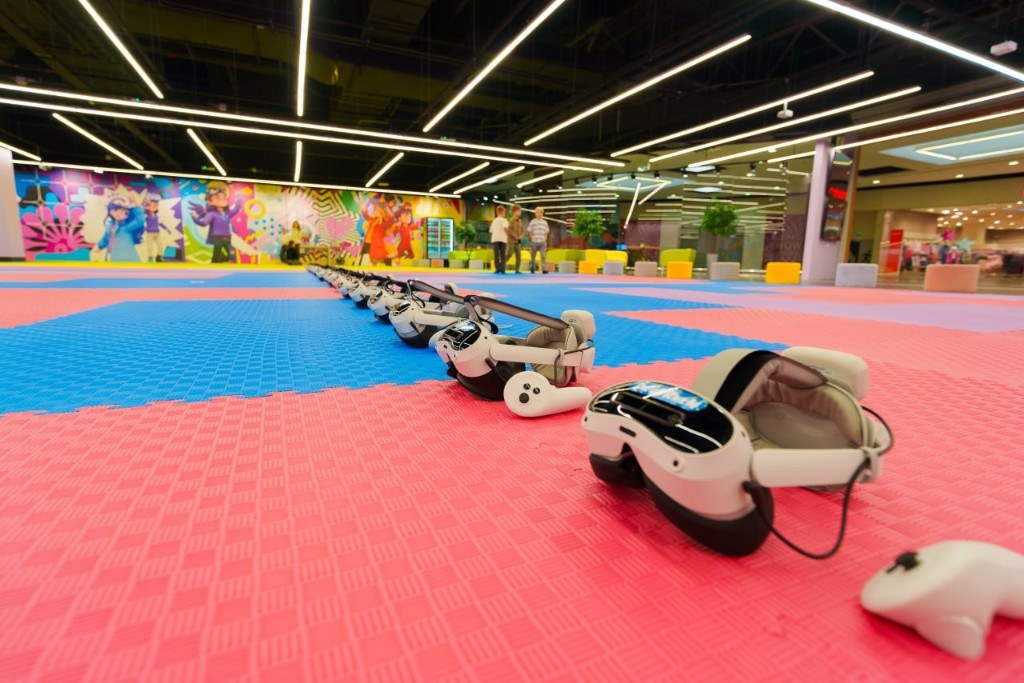VR headsets on a colorful arena floor
