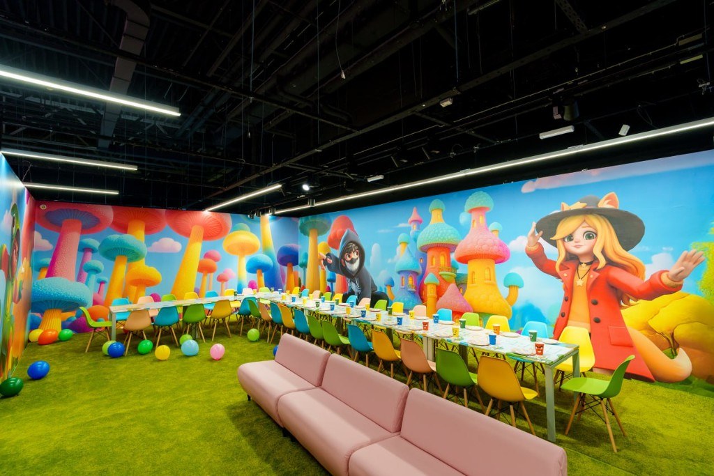 Party room with a colorful mural and long table
